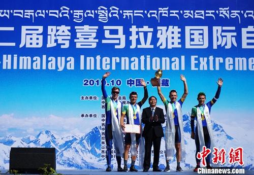 10月10日，2019第二届跨喜马拉雅国际自行车极限赛在西藏拉萨落下帷幕。图为西藏自治区主席齐扎拉（中）为获得团体冠军的乌克兰科尔斯洲际队颁奖。 张伟 摄